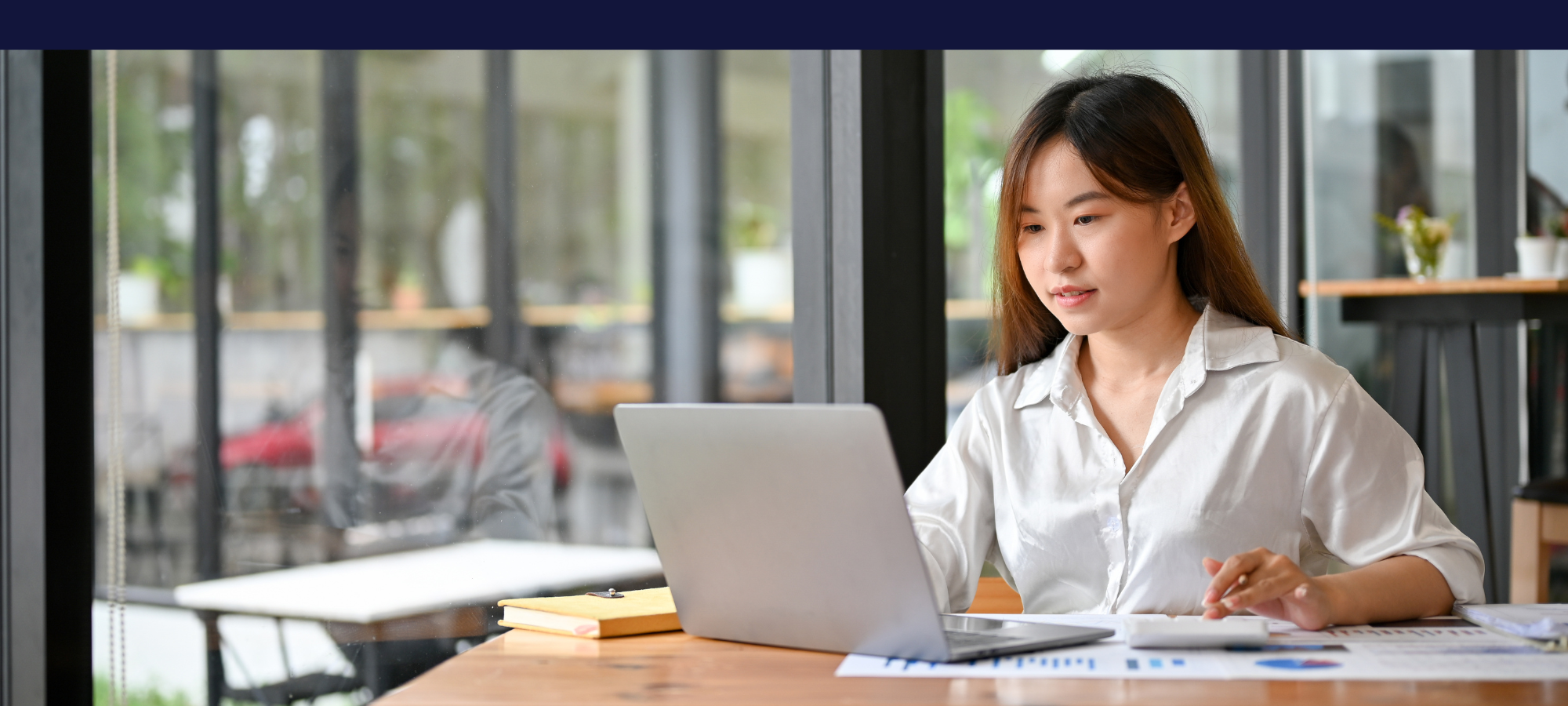 Woman Reviewing Her QuickBooks Data That Was Automatically Synced from OrderScope